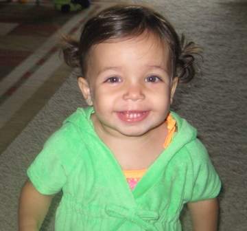 Little girl wearing green smiling
