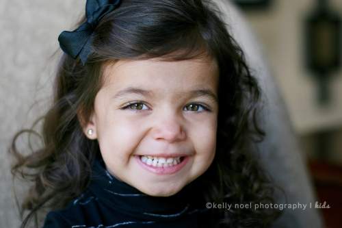 Young girl with bow smiling