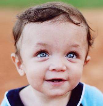 Smiling baby wearing blue